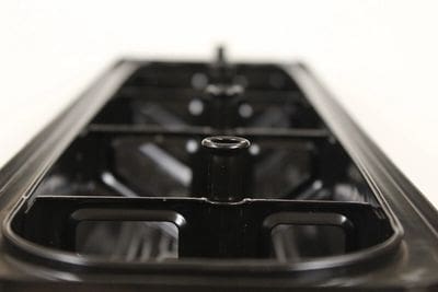 A close up of the bottom of an electric stove.