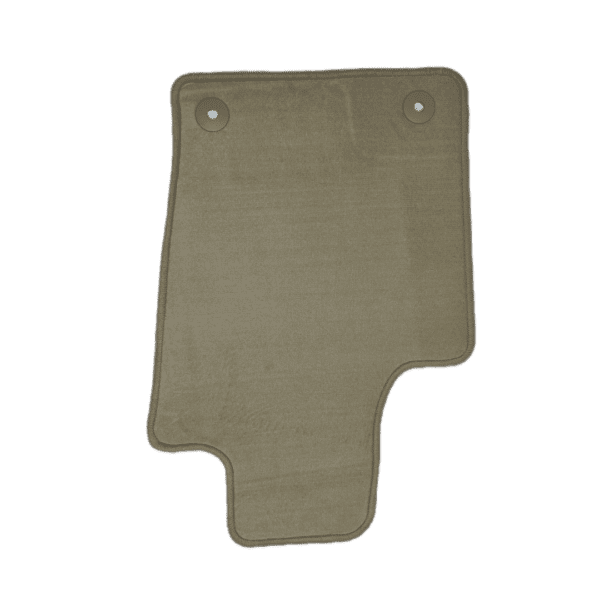 A green floor mat with two holes in it.