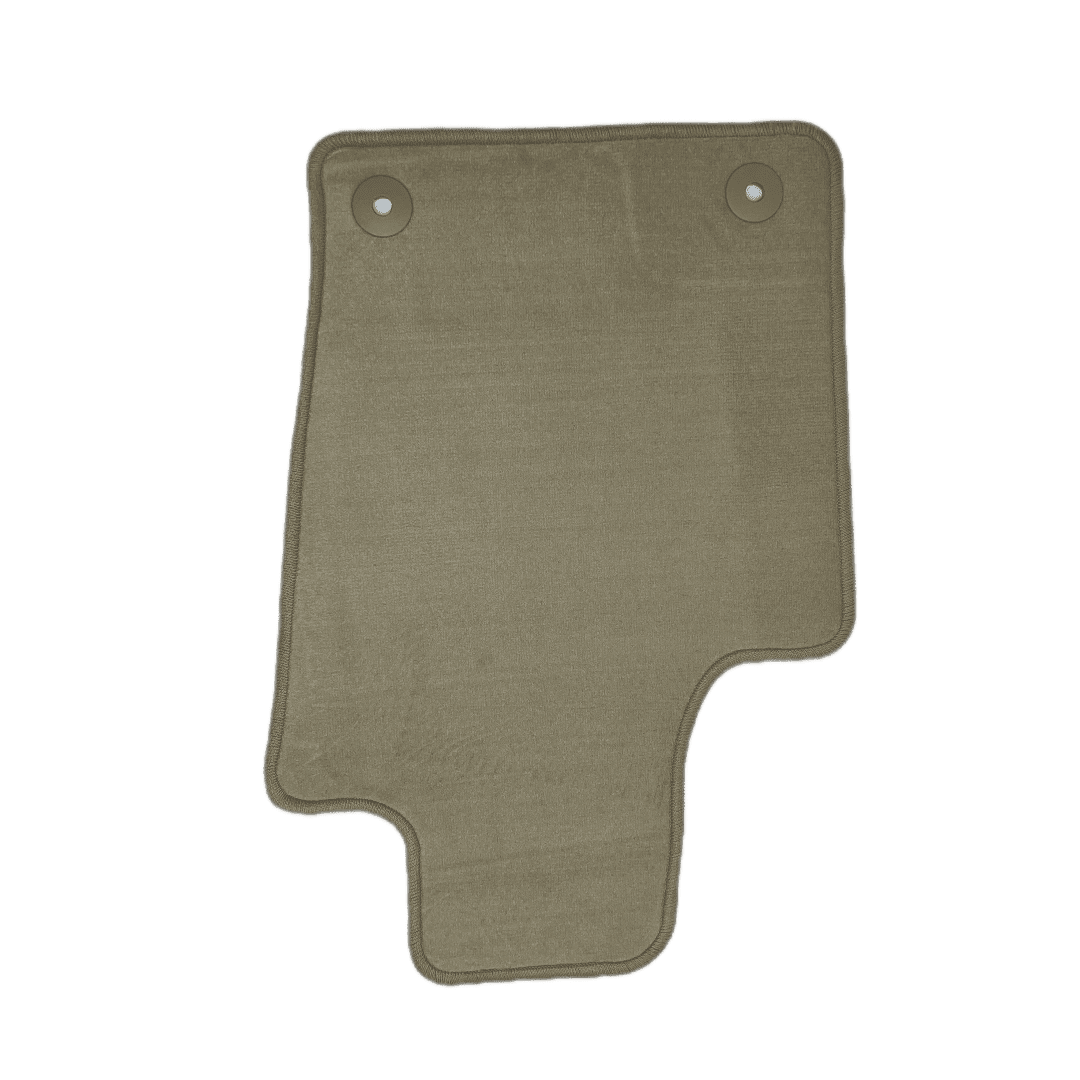 A green floor mat with two holes in it.