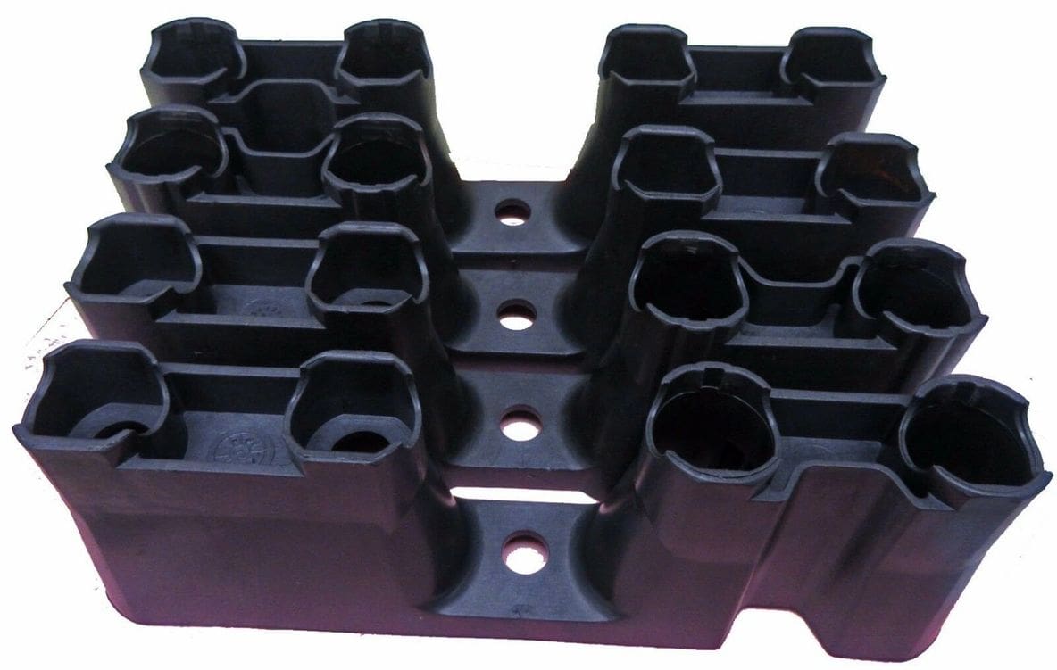 A set of black plastic blocks with holes in them.