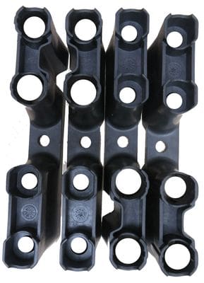 A group of black plastic parts sitting on top of each other.