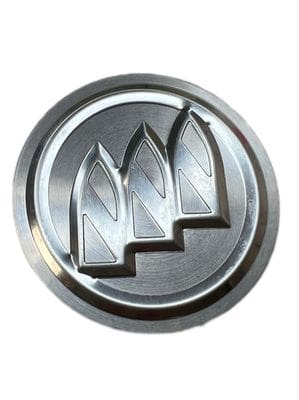 A silver emblem with three lines on it.
