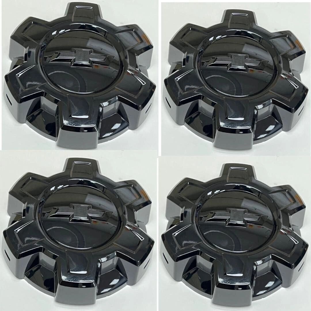 A set of four black wheels with the center one missing.