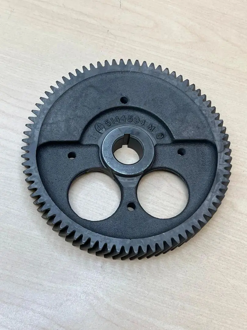A black plastic gear sitting on top of a table.