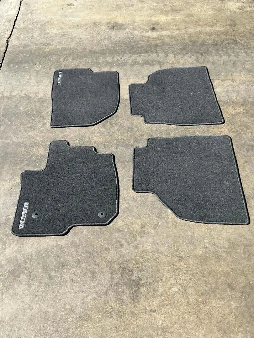 A set of four mats that are on the floor.
