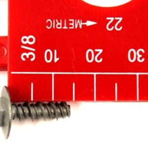 A red ruler with a metal screw and a measuring tape.