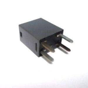 A black relay sitting on top of a white table.