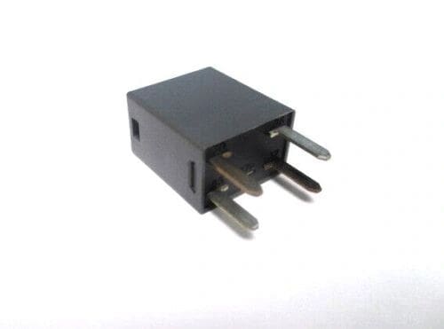 A black relay sitting on top of a white table.