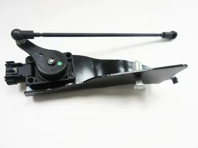 A black bicycle pedal with a green dot on it.