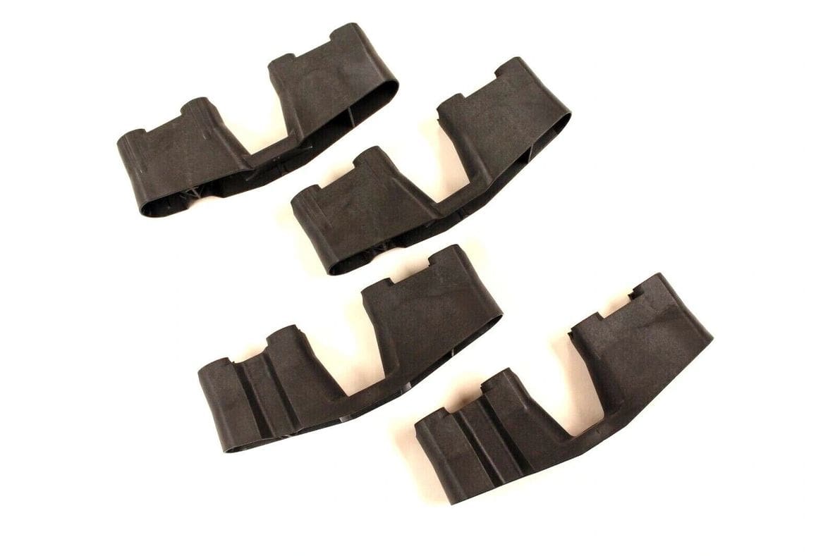 A set of four pieces of black plastic.