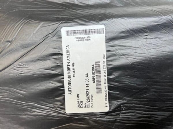A black bag with a white tag and some barcode