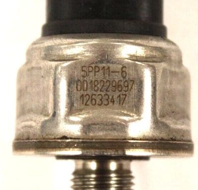 A close up of the side of an oil pressure switch.