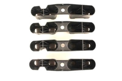 A set of four black plastic handles with holes.