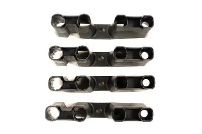 A set of four black plastic brackets with two pairs of clips.